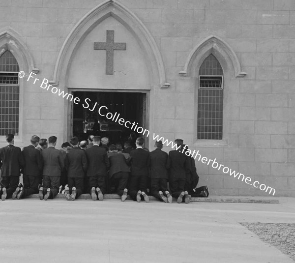 AFTER WOMENS CLOSING MEN KNEELING OUTSIDE CHURCH